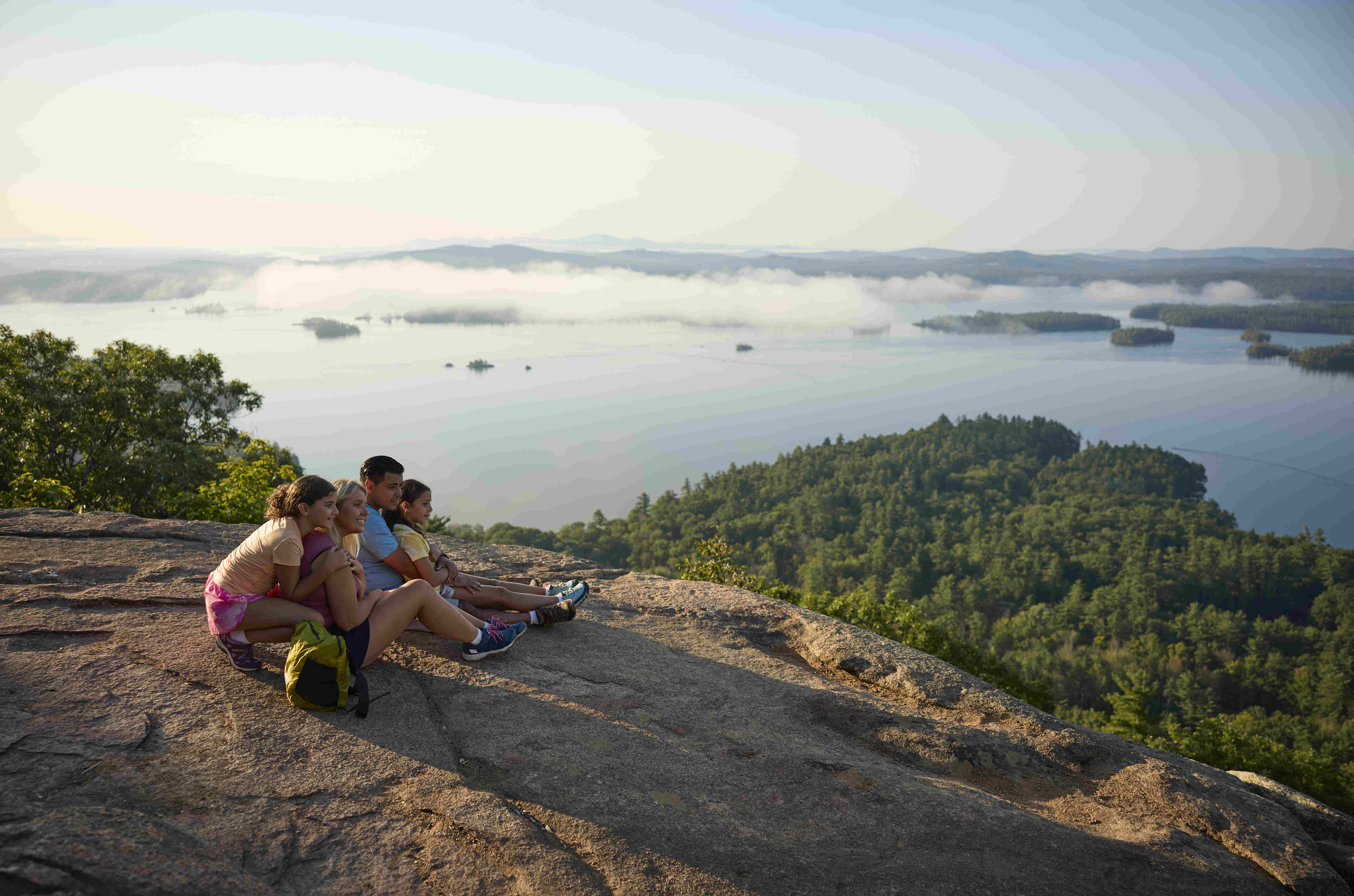 Family enjoying view of the lakes from mountain top.