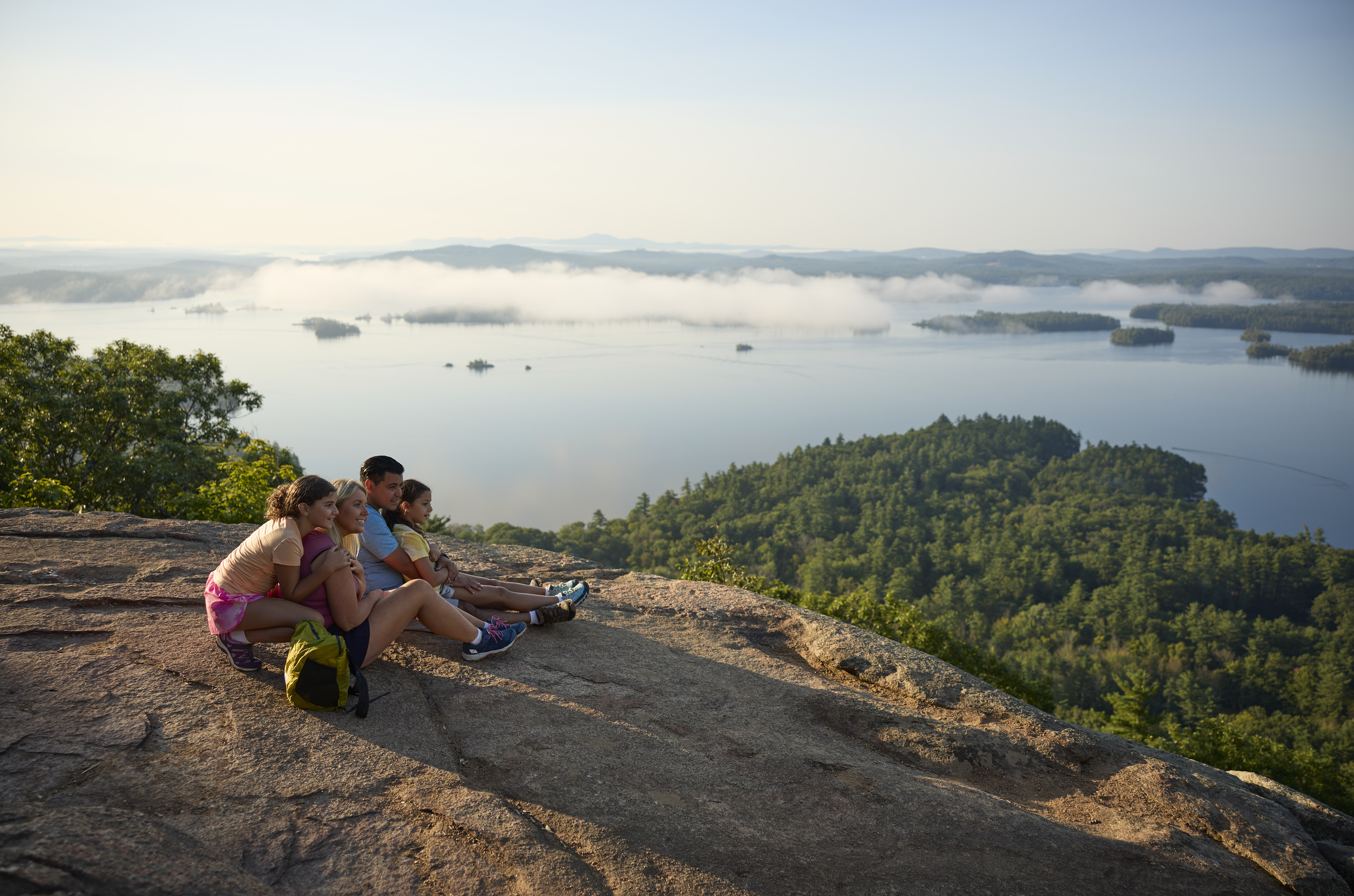 Family enjoying view of the lakes from mountain top.