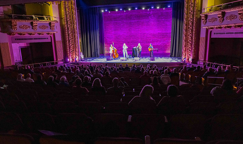 a view of a stage and audience with band playing on stage