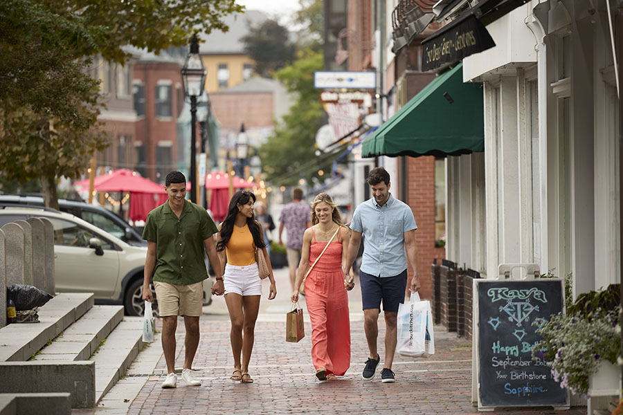 a group of friends walking with shopping bags