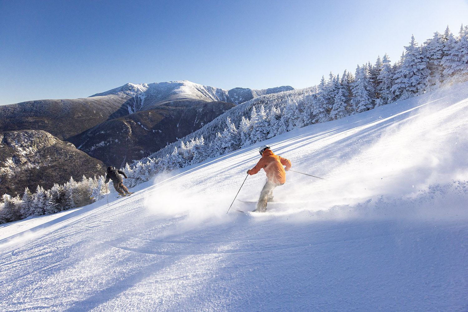 two people skiing down a mountain slope