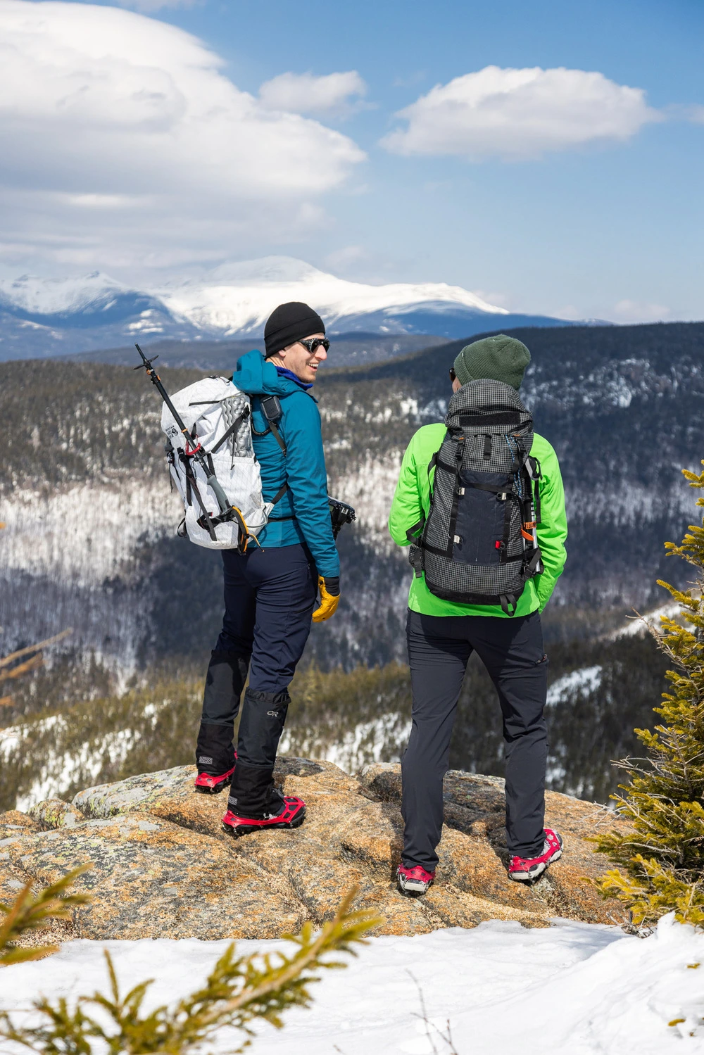 Two people hiking on snowy mountain
