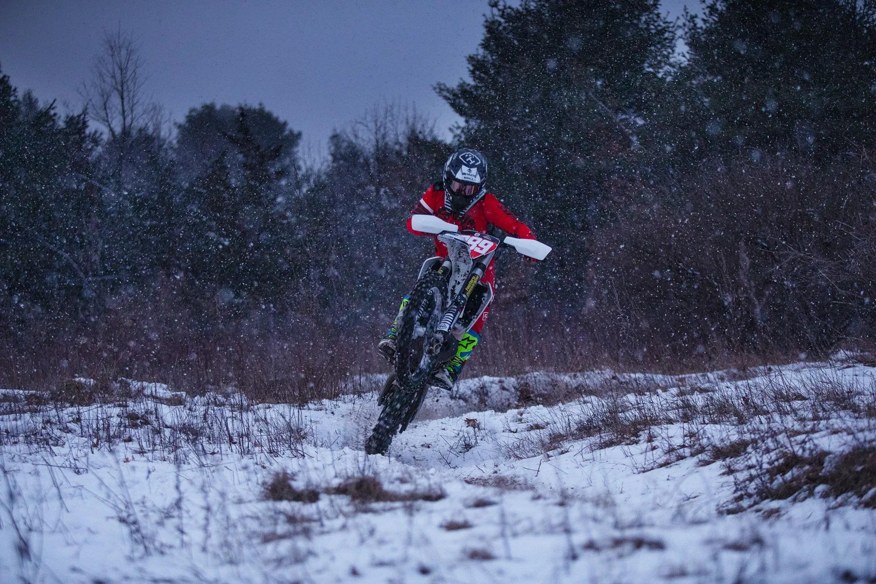 Motorobike rider jumping in the snow